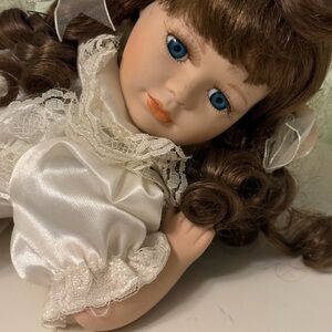 Elegant White Porcelain Doll with Brown Hair and Blue Eyes